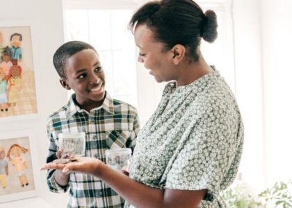 mom teaching her young son about money