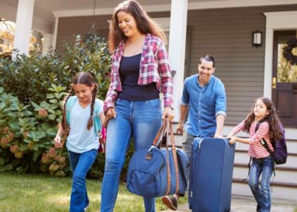 family with suitcases leaving for holiday